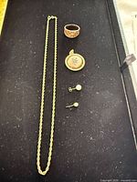 Full lot showing necklace, ring, locket pendant, pearl earrings