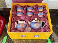 Boxed tea set with two pots, eight cups in satin-lined case