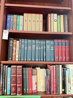 Three shelves packed with assorted hardcover volumes in multiple sets and subjects