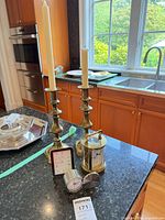 Lot overview showing both candlesticks and three clocks on countertop