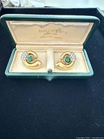 Front view of earrings in Toni Cavelti box