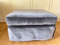Front view of grey velveteen footstool
