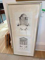 Full view of framed architectural print leaning against wall