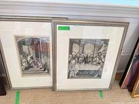 Front view of both framed prints leaning against wall