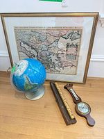 Group shot of map, globe, barometer, flute