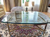 Full view of square glass top coffee table on rug