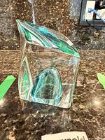 Side view showing faceted clear glass and internal teal element