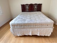 Full view of bed showing headboard, mattress and frame