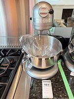 Front view of KitchenAid stand mixer with bowl and whisk inside