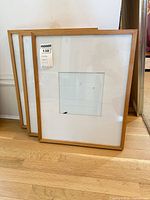 Three fir wood frames leaning on wall