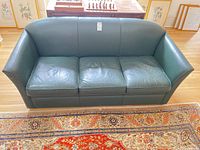 Front view of green leather three-seat sofa