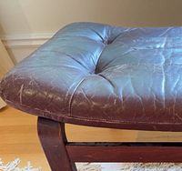 Side view showing leather cushion and wood leg frame