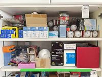 Shelf view showing numerous boxed and loose bulbs of multiple brands and types
