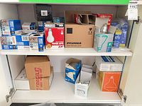 Cabinet shelves with multiple boxed light bulbs from various brands