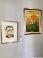 Both artworks hanging side by side on wall