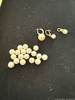 Group of loose pearls with two leverback fittings