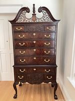 Full view of mahogany highboy showing all drawers, cabriole legs, ball-and-claw feet