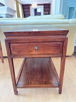 Front view showing drawer, legs and shelf