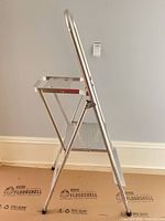 Side view showing aluminum frame, two steps, handrail