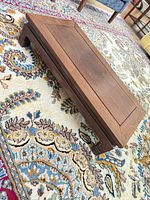 Full view of rectangular low wooden coffee table on rug