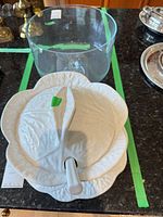 Tureen with lid beside clear trifle bowl