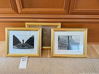 Three matching gold frames, two with Paris prints