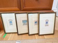 Group shot of all four framed prints standing side by side