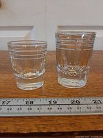 Both shot glasses side by side showing measurement lines and LLBO approval