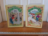 Both hardcover storybooks standing side by side showing front covers