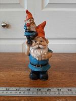 Front view of full figurine showing overall design and ruler for scale