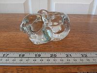 left side profile of glass bunny showing ruler for scale