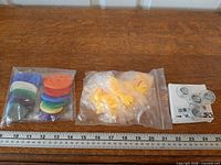 Full lot showing three packaged items and ruler for scale