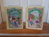 Both Cabbage Patch Kids hardcover books standing upright, full front covers visible