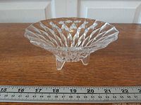 Side view of footed cut crystal bowl showing diamond burst cuts and scale