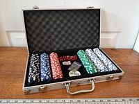 Open briefcase showing chips, dice, dealer button and keys