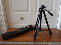 Tripod standing with folded carrying bag