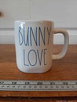 Front view showing blue “BUNNY LOVE” text and size reference