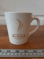Front view of mug showing logo and handle