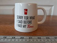 Front view of mug showing full graphic and ruler for scale