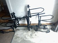 Full view of folded hitch rack showing wheel trays and center arm
