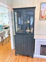 Front view of full hutch showing glass doors, lower cabinet, overall finish