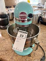 Full view of mixer with bowl and whisk on countertop