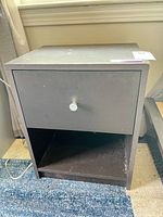 Front view showing drawer, open shelf, overall design
