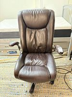 Front view of brown faux leather office chair showing overall design