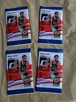Front view of four sealed Panini Donruss packs