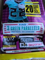 Close-up front of a pack highlighting 20 cards per pack and 3 green parallels