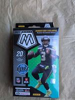 Front of sealed 2021 Panini Mosaic NFL hanger box showing Russell Wilson and product details