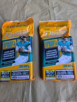 Front view of two sealed Panini Prestige 30-card packs