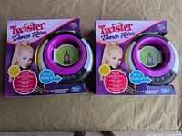 Both sealed Twister Dance Rave game boxes front view