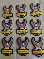 Front view showing nine identical Honda eagle patches